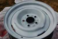 Photo of the trailer wheel after we sprayed on 2 coats of the gloss white paint